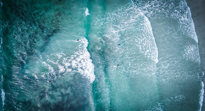 Waves and surfers by the air enrapture captivating media