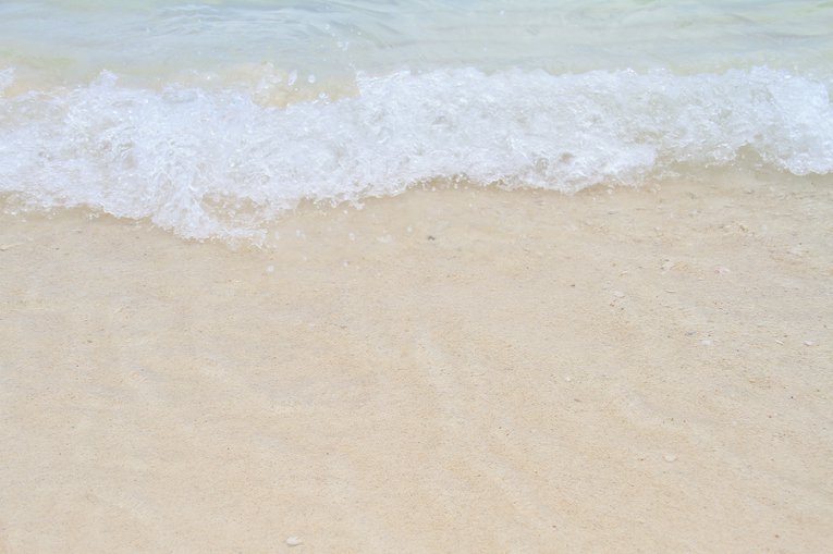 Wave breaks on a sandy beach Theerasak Tammachuen